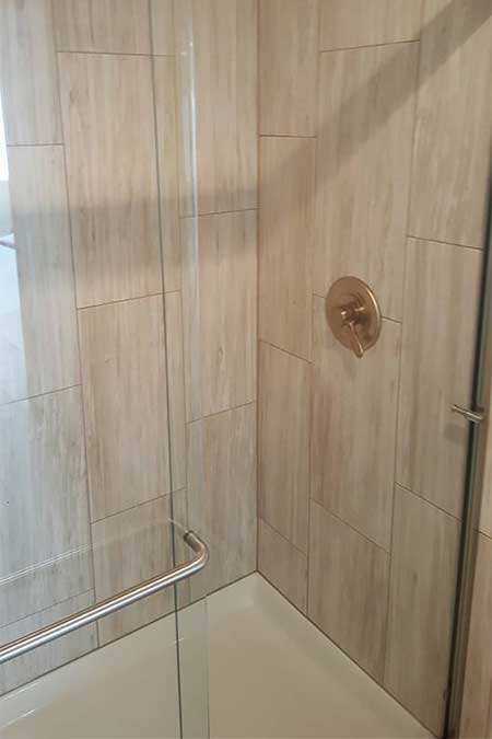 A shower with a glass divider