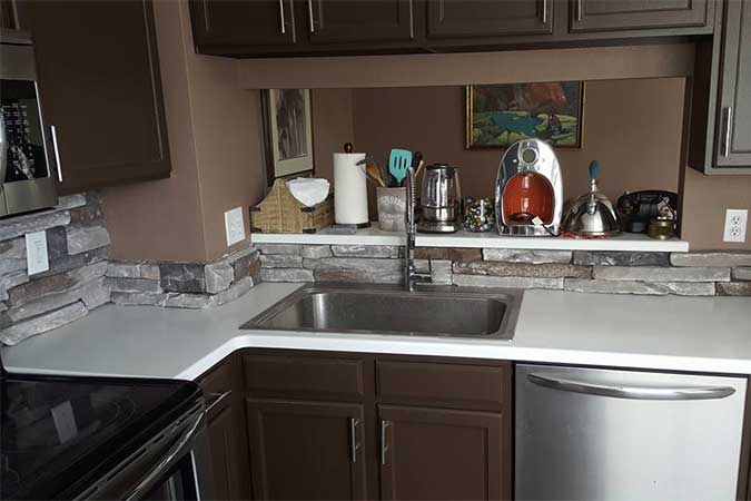 A kitchen with white countertops