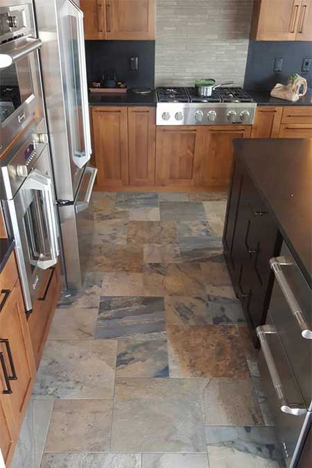 A kitchen with multi-colored flooring