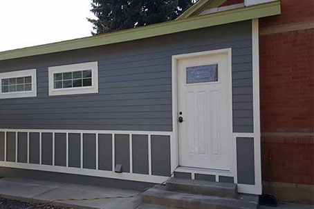 A home addition with blue walls and a white door