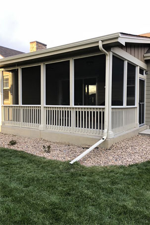 A home addition with a white fence